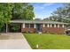 Brick home with a well-kept lawn, stylish landscaping, and a convenient carport at 2521 Whites Mill Ln, Decatur, GA 30032