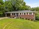 Attractive brick home on a lush lawn, featuring a carport and tasteful landscaping at 2521 Whites Mill Ln, Decatur, GA 30032