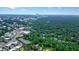 An aerial view showcases the city skyline with lush green landscape in the foreground at 3734 Powers Ferry Nw Rd, Atlanta, GA 30342