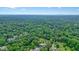 Expansive aerial view showcasing a dense forest landscape with houses nestled among the trees for privacy at 3734 Powers Ferry Nw Rd, Atlanta, GA 30342