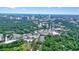 An aerial view showcases the city skyline with lush green landscape in the foreground at 3734 Powers Ferry Nw Rd, Atlanta, GA 30342