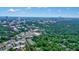 An aerial view showcases the city skyline with lush green landscape in the foreground at 3734 Powers Ferry Nw Rd, Atlanta, GA 30342