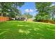 Expansive backyard with lush green lawn and privacy fence, creating a serene outdoor oasis at 3734 Powers Ferry Nw Rd, Atlanta, GA 30342