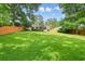 Expansive backyard with a lush lawn, mature trees, and a deck perfect for outdoor entertaining at 3734 Powers Ferry Nw Rd, Atlanta, GA 30342