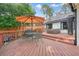 Enjoy the back deck with hot tub, umbrella-covered table, and a grill, ideal for outdoor relaxation and gatherings at 3734 Powers Ferry Nw Rd, Atlanta, GA 30342