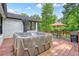 The backyard has a hot tub, string lights, patio furniture, and a grill that are perfect for outdoor entertaining at 3734 Powers Ferry Nw Rd, Atlanta, GA 30342