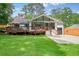 Charming home featuring a large deck, garage, and lush green lawn perfect for outdoor living at 3734 Powers Ferry Nw Rd, Atlanta, GA 30342