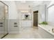 Bright bathroom features tiled floors, skylights, soaking tub, and glass-enclosed shower at 3734 Powers Ferry Nw Rd, Atlanta, GA 30342