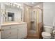 This bathroom features a tiled shower, white cabinets, and modern fixtures for a sleek, functional space at 3734 Powers Ferry Nw Rd, Atlanta, GA 30342