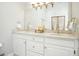 Bathroom vanity with double sinks, granite countertops, and a large mirror with ornate lighting fixtures at 3734 Powers Ferry Nw Rd, Atlanta, GA 30342