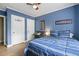 Bedroom with crown molding, two closets, wood floors and blue accent wall at 3734 Powers Ferry Nw Rd, Atlanta, GA 30342