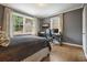 Bedroom features two windows, hardwood floors, and a bed with dark bedding at 3734 Powers Ferry Nw Rd, Atlanta, GA 30342