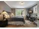 The bedroom has wood floors, modern decor, and a window providing natural light for a warm, inviting atmosphere at 3734 Powers Ferry Nw Rd, Atlanta, GA 30342
