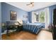 This bedroom features wood floors, a ceiling fan, and large windows offering natural light and a comfortable space at 3734 Powers Ferry Nw Rd, Atlanta, GA 30342