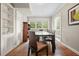Bright dining room with hardwood floors, built-in shelves, and a view of the outdoors through the windows at 3734 Powers Ferry Nw Rd, Atlanta, GA 30342