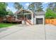 Charming home featuring a large deck and garage, perfect for outdoor living and convenience at 3734 Powers Ferry Nw Rd, Atlanta, GA 30342