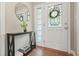 Inviting foyer features a decorative glass door and a stylish console table with a round mirror at 3734 Powers Ferry Nw Rd, Atlanta, GA 30342