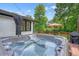 Relaxing hot tub on a wooden deck, surrounded by trees and ambient string lights for evening enjoyment at 3734 Powers Ferry Nw Rd, Atlanta, GA 30342