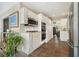 Open kitchen with stainless steel appliances, white cabinetry, and stone flooring at 3734 Powers Ferry Nw Rd, Atlanta, GA 30342