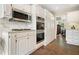 Kitchen featuring marble countertops, stainless steel appliances, and white cabinetry at 3734 Powers Ferry Nw Rd, Atlanta, GA 30342