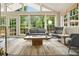 Bright sunroom featuring large windows, neutral furniture, and an area rug on the floor at 3734 Powers Ferry Nw Rd, Atlanta, GA 30342