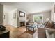 Cozy living room with hardwood floors, fireplace, and a large window overlooking the backyard at 3734 Powers Ferry Nw Rd, Atlanta, GA 30342