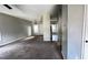 View of a living room with a doorway to another room and dark stained carpet at 5415 Twin Lakes Dr, Atlanta, GA 30349