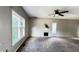 Spacious living room with fireplace, ceiling fan, and large windows providing natural light at 5415 Twin Lakes Dr, Atlanta, GA 30349