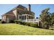 Large backyard with a deck, screened porch, and green lawn at 6529 Terraglen Way, Locust Grove, GA 30248
