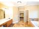 Spacious primary bathroom with double vanity, soaking tub, and access to a walk-in closet at 6529 Terraglen Way, Locust Grove, GA 30248