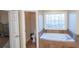 Elegant bathroom featuring a jacuzzi tub with decorative window and private toilet room at 6529 Terraglen Way, Locust Grove, GA 30248