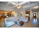Open-concept living room featuring coffered ceilings and seamless flow to the kitchen at 6529 Terraglen Way, Locust Grove, GA 30248