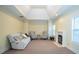 Bright living room featuring a fireplace, comfortable seating, and a unique tray ceiling at 6529 Terraglen Way, Locust Grove, GA 30248