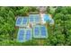 Aerial view of tennis courts and a pool nestled among the trees in the community at 1124 Monarda Nw Way, Acworth, GA 30102