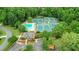Community aerial view featuring tennis courts, a pool, and surrounded by lush greenery at 1124 Monarda Nw Way, Acworth, GA 30102