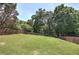 Expansive backyard with lush green grass and a wooden fence surround at 1124 Monarda Nw Way, Acworth, GA 30102