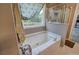 A white soaking tub is featured in this bathroom with shower and outdoor view at 1124 Monarda Nw Way, Acworth, GA 30102