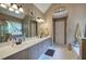 A large bathroom features double sinks, decorative mirrors, and a large soaking tub at 1124 Monarda Nw Way, Acworth, GA 30102