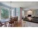Open dining area features natural light, blue walls and view of modern kitchen at 1124 Monarda Nw Way, Acworth, GA 30102
