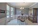 Bright dining room with bay windows, chandelier, and neutral wall colors at 1124 Monarda Nw Way, Acworth, GA 30102