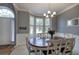 Elegant dining room with bay window, chandelier, and wainscoting at 1124 Monarda Nw Way, Acworth, GA 30102