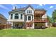 Rear view of a multi-level home with decks and a large backyard at 1124 Monarda Nw Way, Acworth, GA 30102