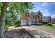 Beautiful brick home with manicured lawn, two-car garage, and mature trees at 1124 Monarda Nw Way, Acworth, GA 30102