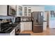 Stylish kitchen showcases white cabinets, black countertops, stainless appliances, and hardwood floors at 1124 Monarda Nw Way, Acworth, GA 30102