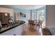 Eat-in kitchen features a black granite counter island, stainless steel appliances, and hardwood floors at 1124 Monarda Nw Way, Acworth, GA 30102