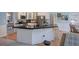 Modern kitchen with a large island, stainless appliances, and white cabinets at 1124 Monarda Nw Way, Acworth, GA 30102