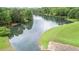 Scenic lake view surrounded by lush greenery and sloping grassy banks at 1124 Monarda Nw Way, Acworth, GA 30102