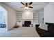 Bright living room offers a ceiling fan, fireplace, and built in shelves for plenty of storage at 1124 Monarda Nw Way, Acworth, GA 30102