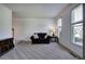 Cozy living room with neutral carpet, sofa, and ample natural light at 1124 Monarda Nw Way, Acworth, GA 30102