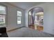 Comfortable living room with plush carpet, bright windows, and archway to dining area at 1124 Monarda Nw Way, Acworth, GA 30102